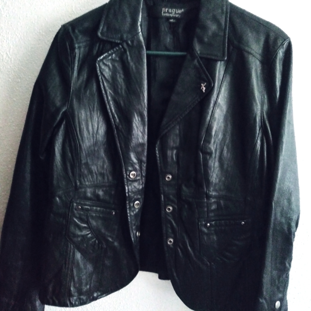 Genuine Leather jacket by Prague size large. The jacket rests on the waist